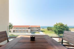 a wooden table with a view of a building at 9 DOORS in Perea