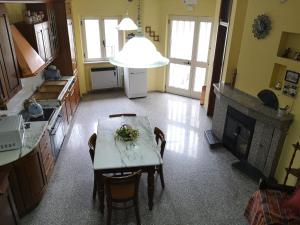a kitchen with a table with chairs and a fireplace at Casa Vacanze Manzoni Abriola in Abriola