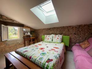 a bedroom with a large bed and a skylight at La Chevalière Sauvage in Tourves