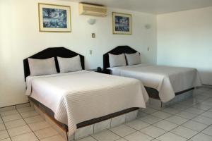 Tempat tidur dalam kamar di Hotel La Quinta Bonita