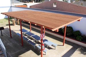 awning on top of a building with chairs under it at Hotel La Quinta Bonita in Ensenada