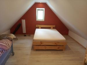 a bedroom with a bed in a attic at Domek w lesie in Biłgoraj