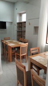 a dining room with wooden tables and chairs at Hotel Plaza in Coronel Suárez