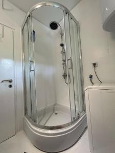 a shower with a glass enclosure in a bathroom at Apartmani Nada in Drage +28 photos