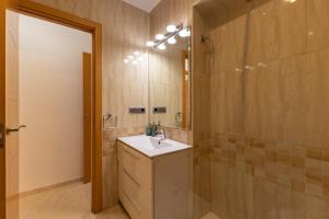 a bathroom with a sink and a mirror at Charming 3 Bedroom Apartment at Triana Center By Oui Seville in Seville