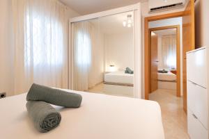 a bedroom with a white bed with a mirror at Charming 3 Bedroom Apartment at Triana Center By Oui Seville in Seville
