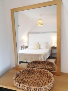 a bedroom with a large mirror and a bed at Lam'Bray in Forges-les-Eaux