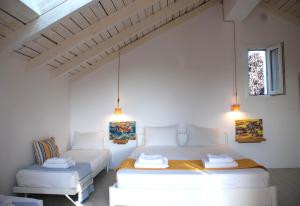a white room with two beds and a couch at Katelios Farm House Loft in Katelios +24 photos