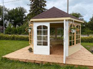 a gazebo with a door on a wooden deck at Paide B&B in Paide