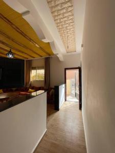 a room with a living room with a kitchen and a living room at HOUSE OF AIT BIHI TAGHAZOUT in Agadir