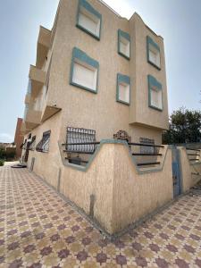 a building with benches on the side of it at HOUSE OF AIT BIHI TAGHAZOUT in Agadir