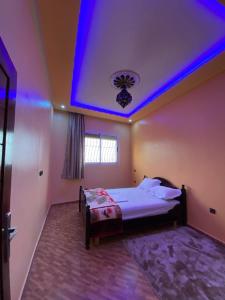 a bedroom with a bed with a blue ceiling at HOUSE OF AIT BIHI TAGHAZOUT in Agadir