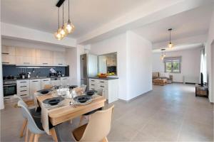 a kitchen with a table and chairs in a room at Tania Villas by PaxosRetreats in Gaios