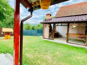 a gazebo with a bench in a yard at Casa Victoria in Cârțișoara