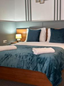 a large bed with two pillows on top of it at Baltrum in Sibiu