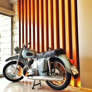 a motorcycle is parked in front of a wall at Nur Hotel in Kaş