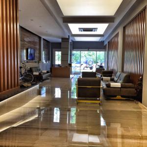 a lobby with couches and chairs in a building at Nur Hotel in Kaş