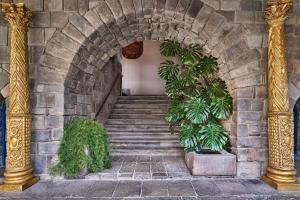 an archway with stairs and plants in a building at Palacio del Inka, a Luxury Collection Hotel, Cusco in Cusco