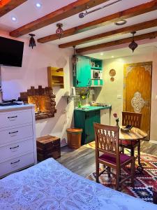 a kitchen with a table and a dining room at Apartman Tuareg in Sarajevo