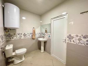 a bathroom with a toilet and a sink and a shower at Tvaliakari in Khulo +53 photos