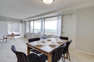 a dining room with a table and chairs with a view at Amazing 2 BR Apt + Den @Crystal City With Gym in Arlington