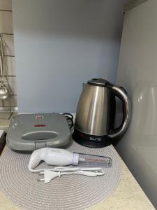 a kitchen counter with a slow cooker and a tea kettle at Maria's Central Apartment in Igoumenitsa