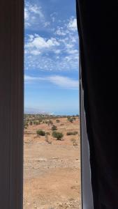 a view of the desert from a window at HOUSE OF AIT BIHI TAGHAZOUT in Agadir