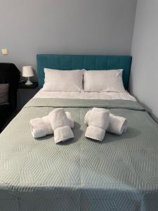 a bed with two towels on top of it at Maria's Central Apartment in Igoumenitsa