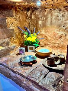 a stone counter with bowls and flowers on it at Apartman Tuareg in Sarajevo