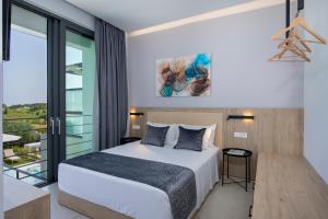 A bed or beds in a room at Cretan Queen Residences