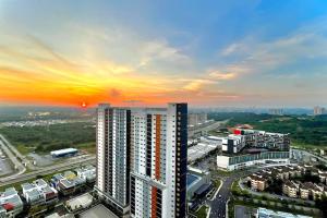 a view of a building with the sunset in the background at 3BR Modern Cozy Suite Near KLIA in Sepang