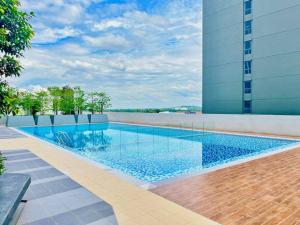 a swimming pool on the side of a building at 3BR Modern Cozy Suite Near KLIA in Sepang