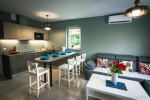 a kitchen and living room with a couch and a table at Apartamenty u Edzi in Zator