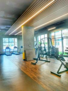 a gym with several treadmills and cardio machines at Cozy Apartment in Jumeirah Village Circle, Dubai. in Dubai