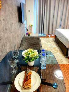 a table with a plate of food on top of it at Cozy Apartment in Jumeirah Village Circle, Dubai. in Dubai