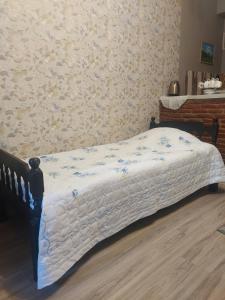 a bed in a bedroom with a wall at Luka in Tbilisi City