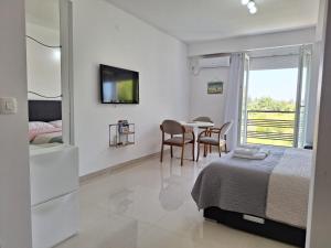 a bedroom with a bed and a table with chairs at Apartments Lakeside Elesec in Ohrid