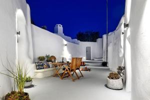 a patio with a table and chairs in a building at Villa Agalitsa Cave Houses with Garden Courtyard in Megalochori