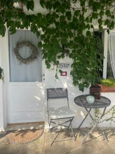 a chair and a table in front of a door at GuestRoom Ia cascina di Bea in Torre Boldone