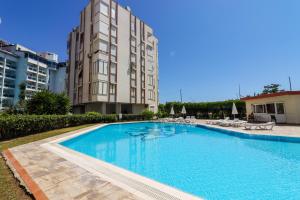 a large swimming pool in front of a building at Sunny Apartment with Fabulous Sea View in Alanya