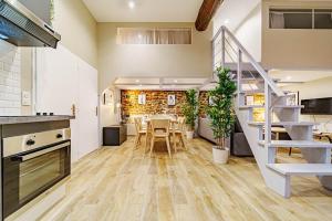 a kitchen and dining room with a staircase in a house at Le loft Montesquieu spacieux 6 pers Saxe Gambetta in Lyon
