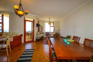 a dining room and living room with a wooden table at Sunny Apartment with Fabulous Sea View in Alanya