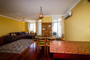 a living room with yellow walls and a table and chairs at Sunny Apartment with Fabulous Sea View in Alanya