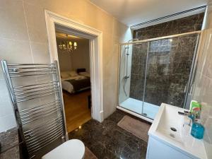 a bathroom with a shower and a sink and a mirror at En Suite Room & Private Bathroom, in Marylebone, Paddington #room name is paris# in London