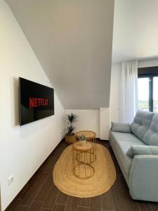 a living room with a couch and a table at Apto Solpor, terraza y parking in Cambados