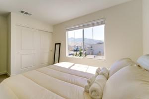 a bedroom with two beds and a large window at Modern Reno Vacation Home Easy Access to Nature in Reno