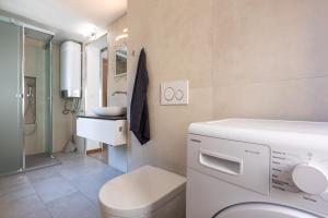 a bathroom with a toilet and a sink at Apartman Stefani in Krk