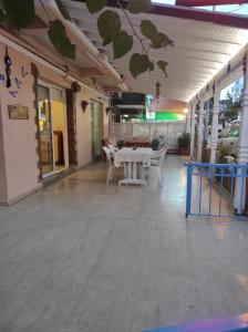 a patio with a table and chairs in a building at AYHAN OTEL in Çeşme