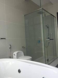 a bathroom with a glass shower with a toilet at Tropicana Grande Luxurious Stay in Kota Damansara