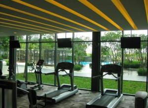 a gym with several cardio machines and a large window at Tropicana Grande Luxurious Stay in Kota Damansara